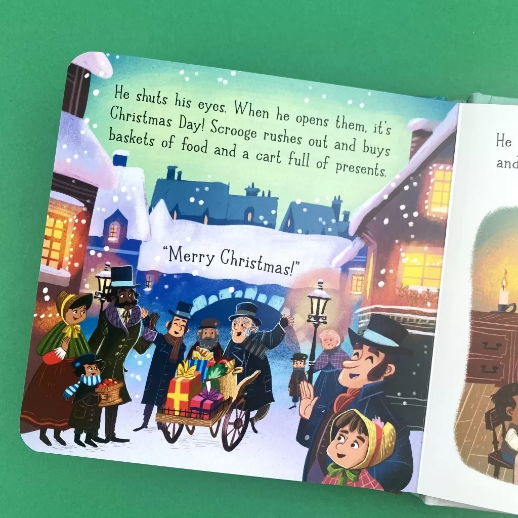 A photo of the open book showing the final scene when Scrooge celebrates Christmas with the townfolk